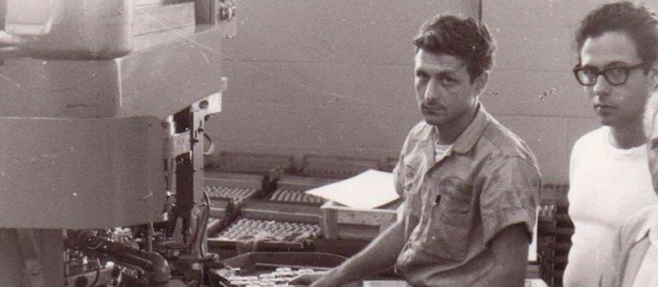 Archival photo: machine operators on the factory floor