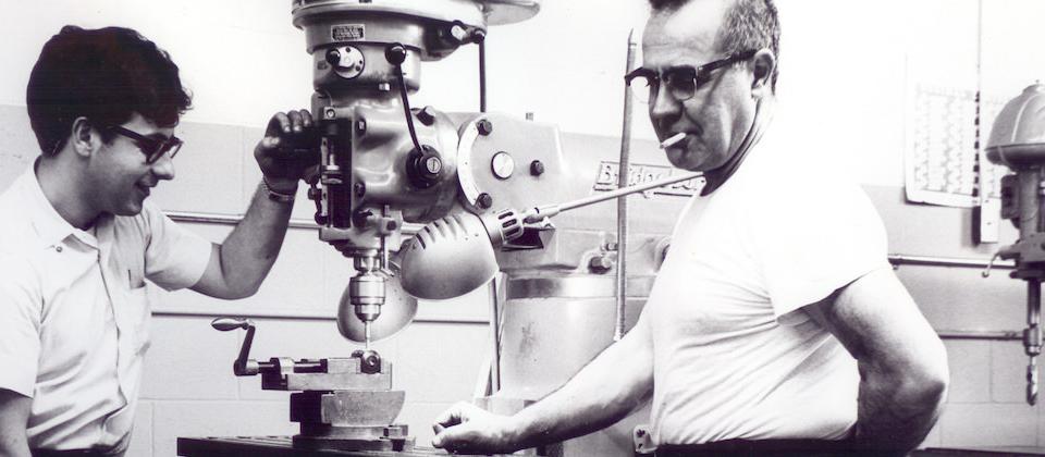 Archival photo: two machinists at a Bridgeport milling machine